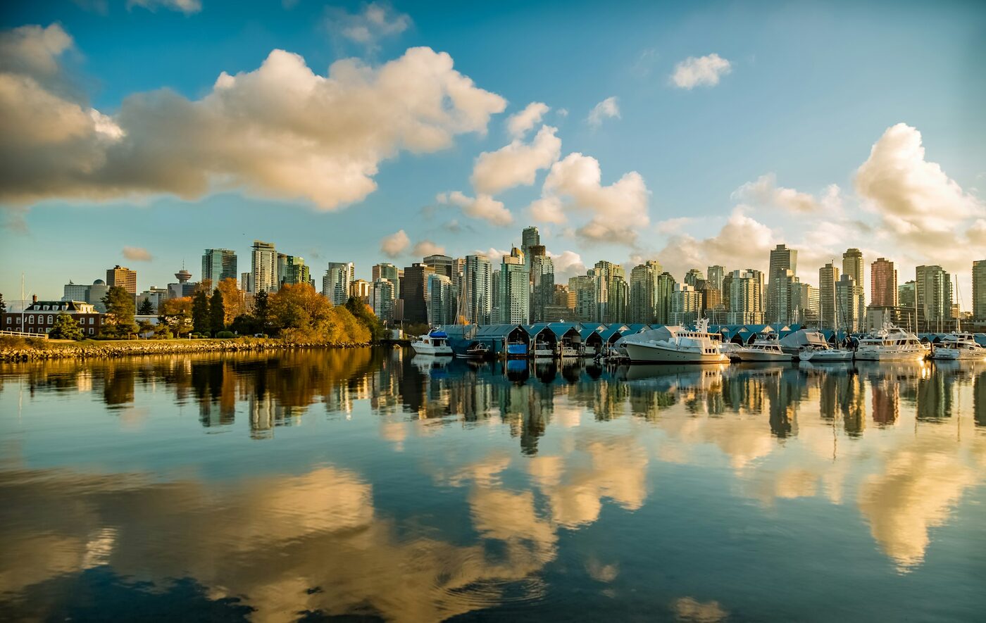 The Vancouver skyline reflected in Coal Harbour at golden hour